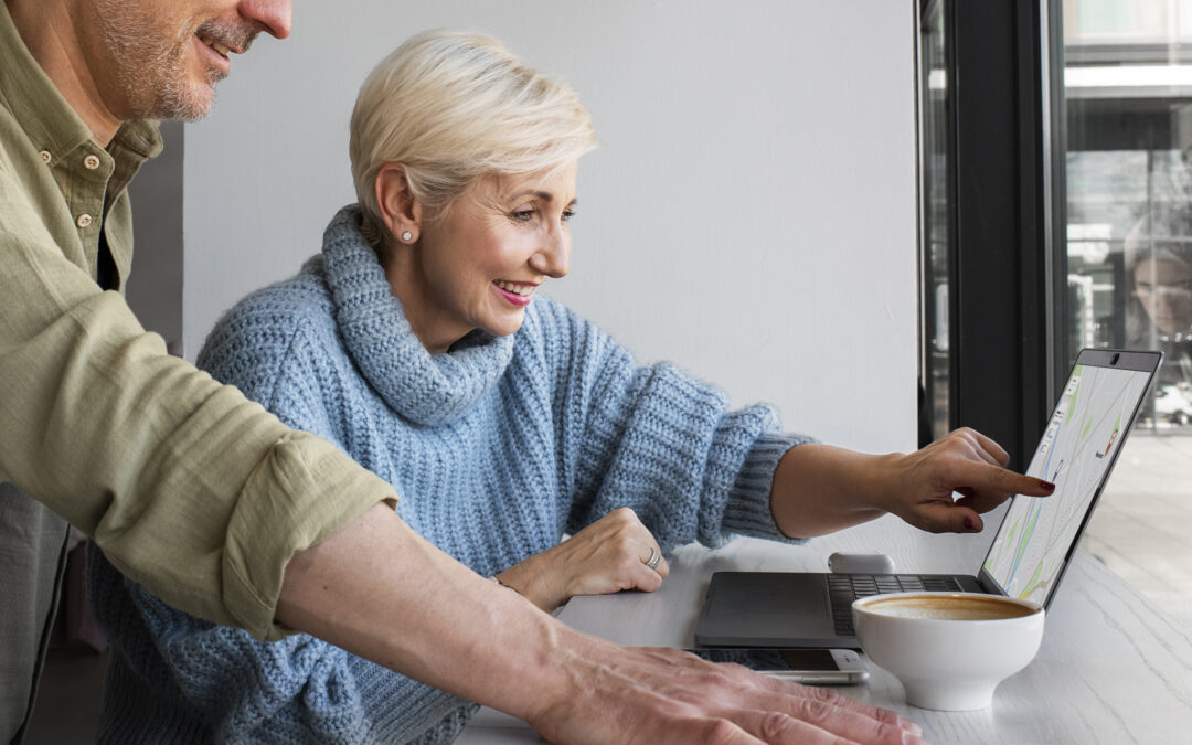 Older couple looking at a laptop computer together.