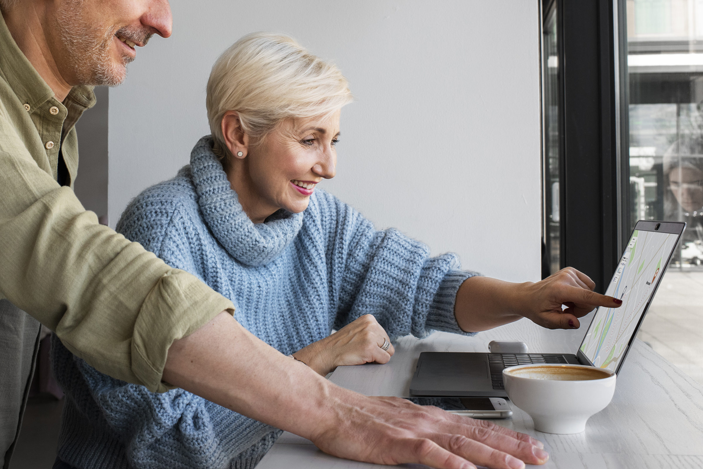 Older couple looking at a laptop computer together.