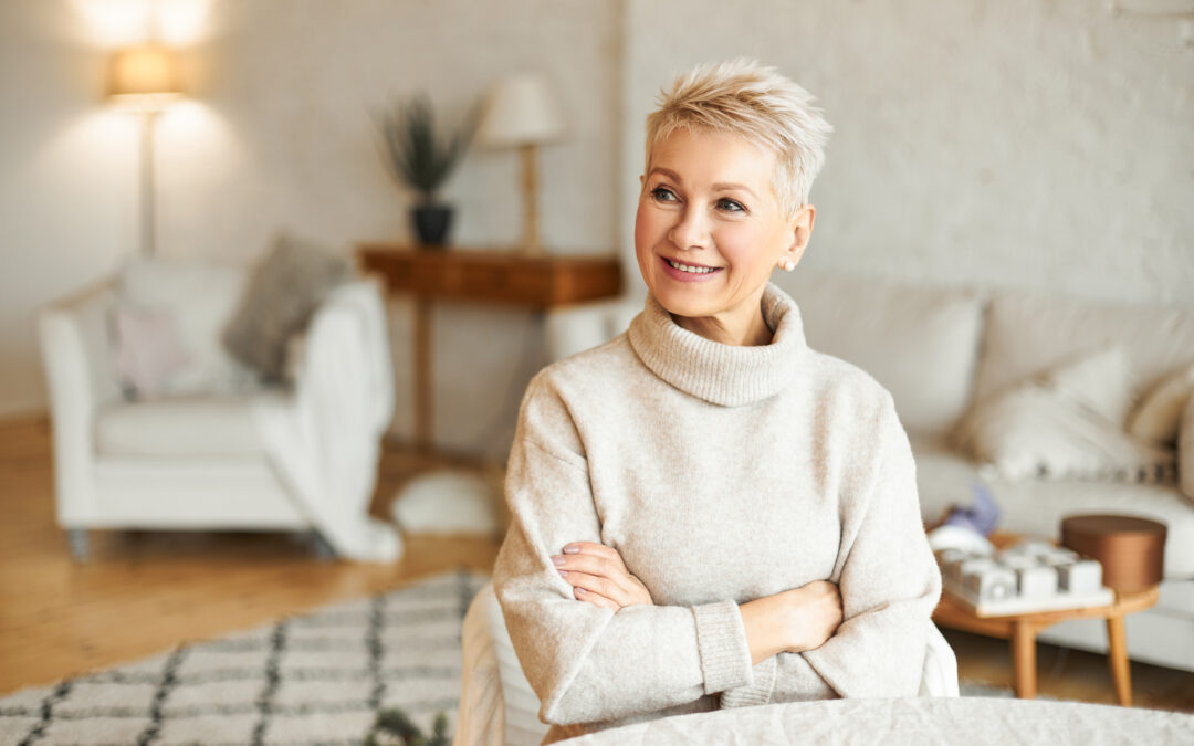 Senior woman smiling in a cozy sweater