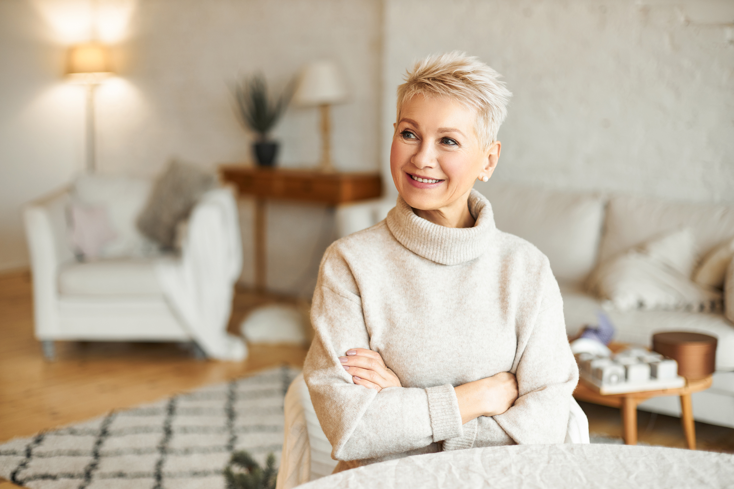 Senior woman smiling in a cozy sweater